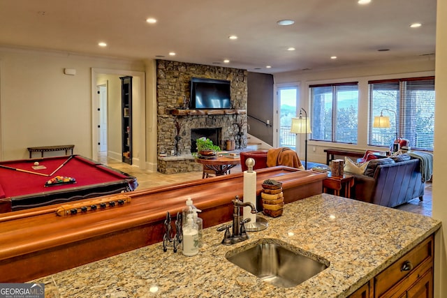 game room with sink, crown molding, a fireplace, and pool table