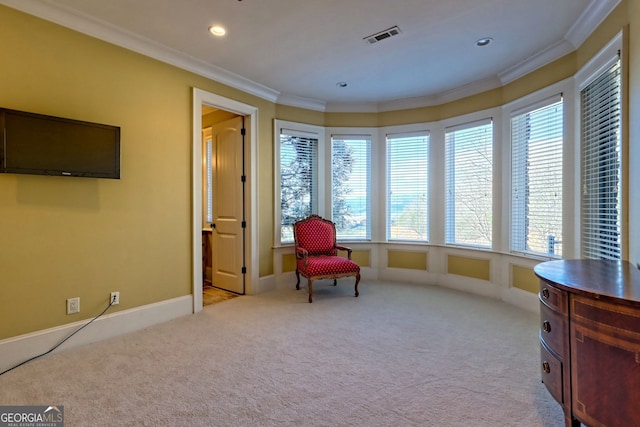 sitting room featuring light colored carpet and ornamental molding