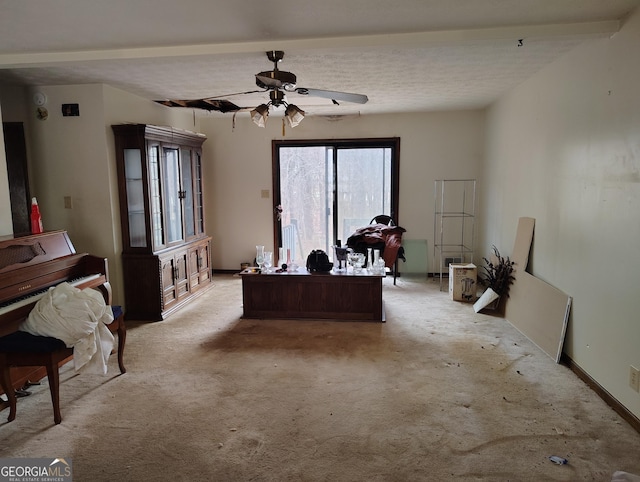 carpeted office with a textured ceiling and ceiling fan