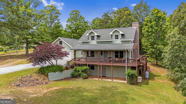 exterior space with a deck and a front yard