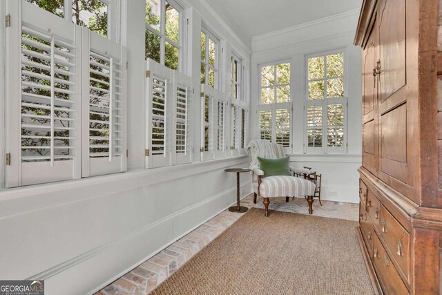 sitting room featuring crown molding