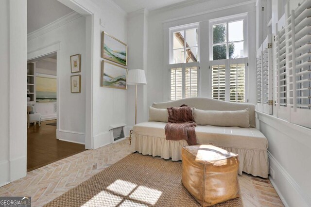 bathroom featuring ornamental molding, plenty of natural light, toilet, and sink