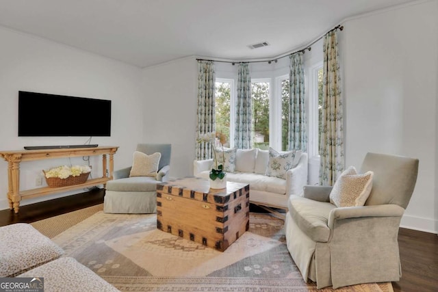 living room with hardwood / wood-style flooring and crown molding