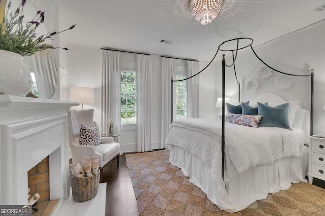 bedroom featuring wood-type flooring and a notable chandelier