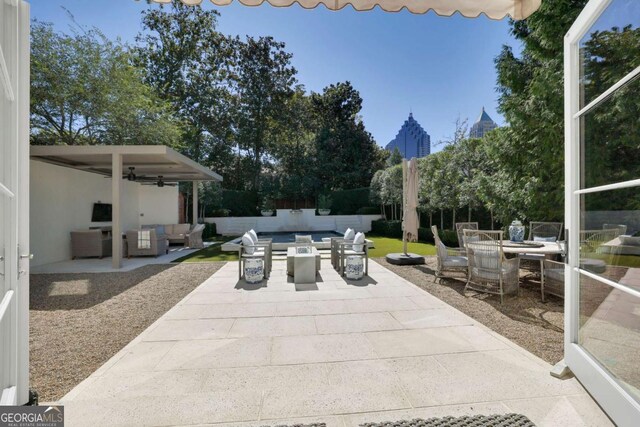 view of patio / terrace with an outdoor living space and ceiling fan