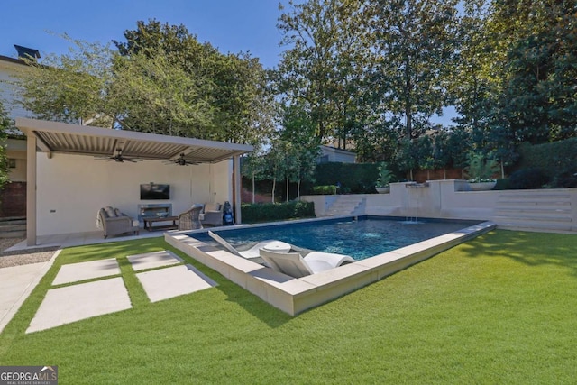 view of swimming pool with a patio, a lawn, pool water feature, and ceiling fan