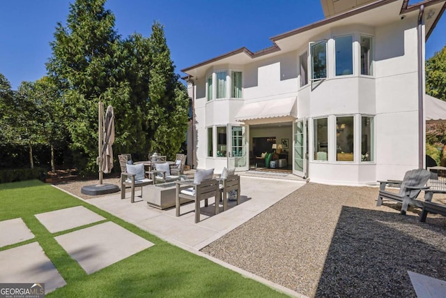 back of property featuring an outdoor hangout area and a patio area