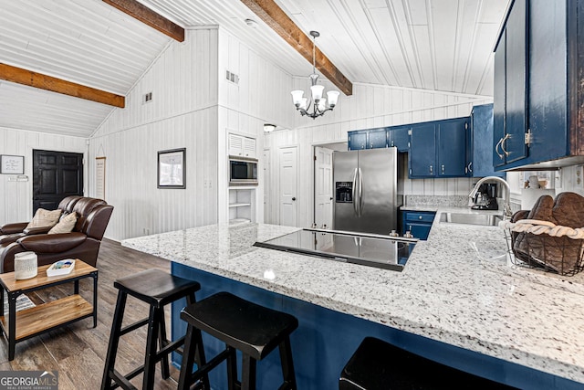 kitchen with built in microwave, blue cabinets, sink, stainless steel fridge, and dark hardwood / wood-style flooring