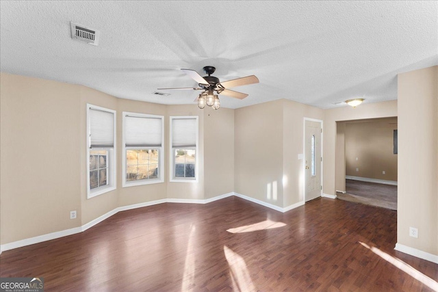 unfurnished room featuring ceiling fan, a textured ceiling, and dark hardwood / wood-style flooring