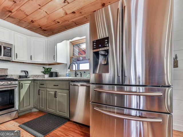 kitchen featuring white cabinetry, appliances with stainless steel finishes, light wood-type flooring, and wooden ceiling