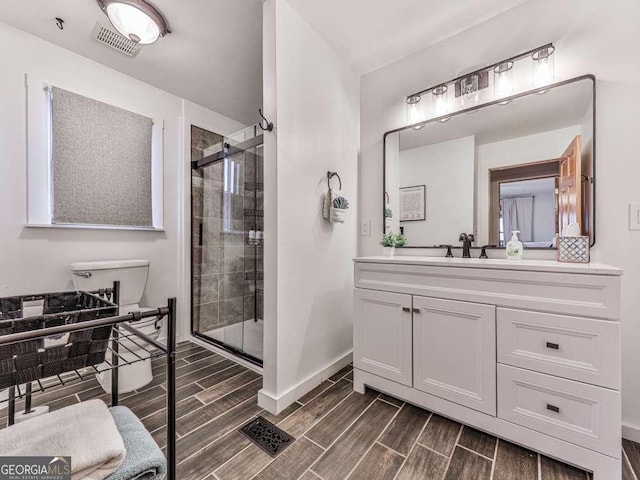 bathroom with vanity and a shower with shower door