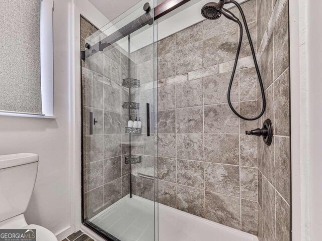 bathroom with toilet and walk in shower