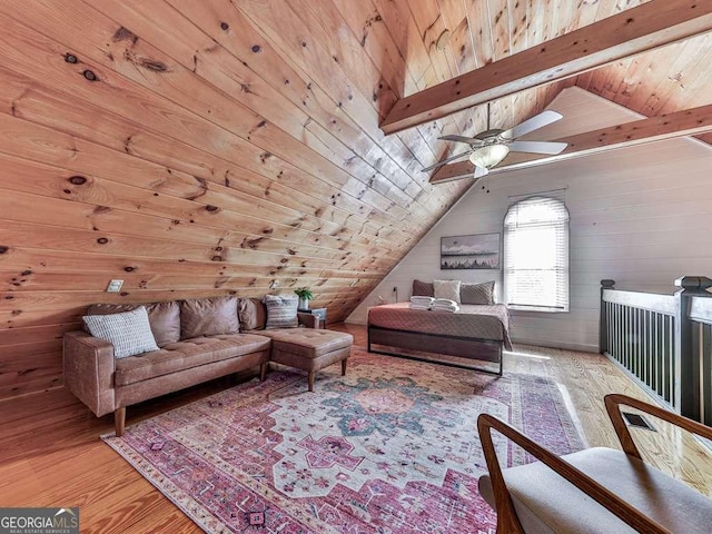 interior space with wood walls, lofted ceiling with beams, hardwood / wood-style flooring, ceiling fan, and wooden ceiling