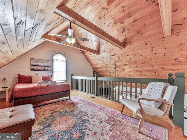 sitting room with wood ceiling, ceiling fan, hardwood / wood-style floors, lofted ceiling with beams, and wood walls