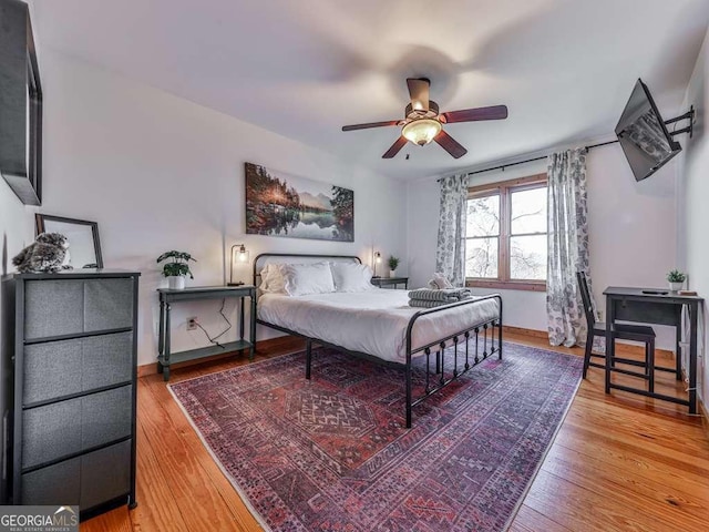 bedroom with hardwood / wood-style flooring and ceiling fan