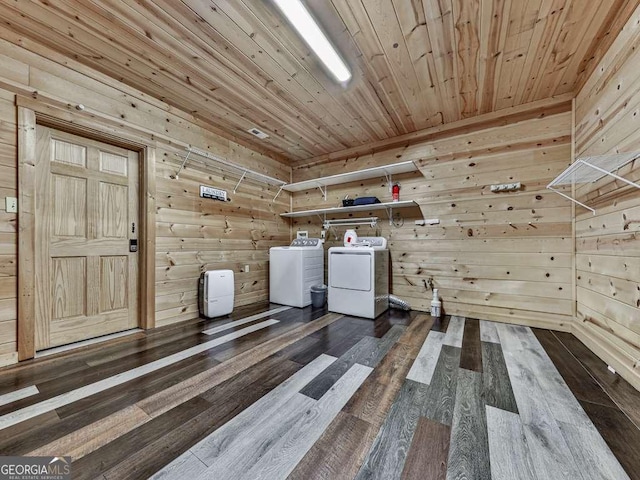 additional living space with wood ceiling, independent washer and dryer, wood-type flooring, and wood walls