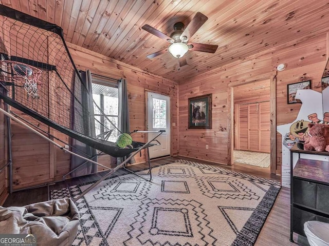 miscellaneous room featuring wood ceiling, ceiling fan, hardwood / wood-style flooring, and wood walls