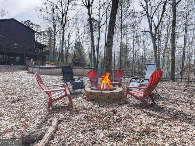 view of patio with an outdoor fire pit and a covered pool