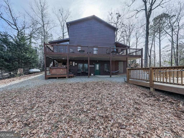 back of house featuring a deck