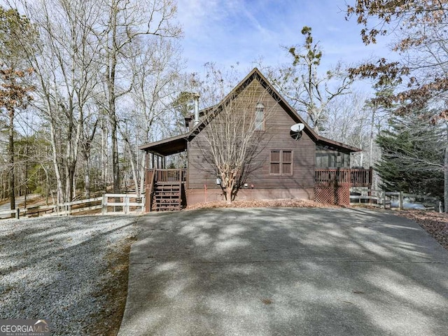 view of home's exterior featuring a wooden deck