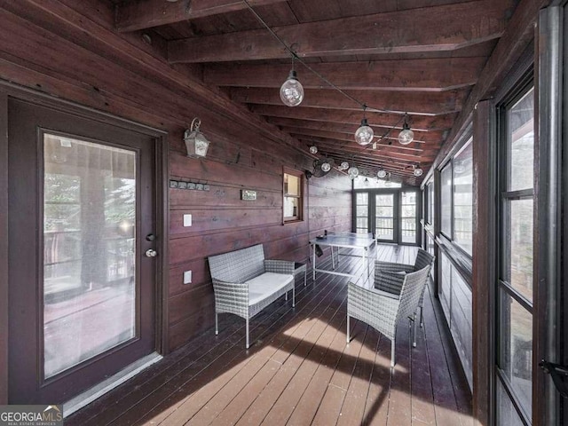 unfurnished sunroom featuring lofted ceiling with beams and wood ceiling