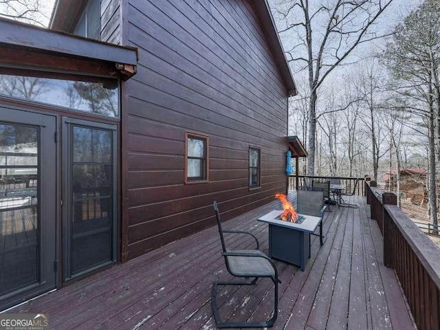 wooden terrace with a fire pit