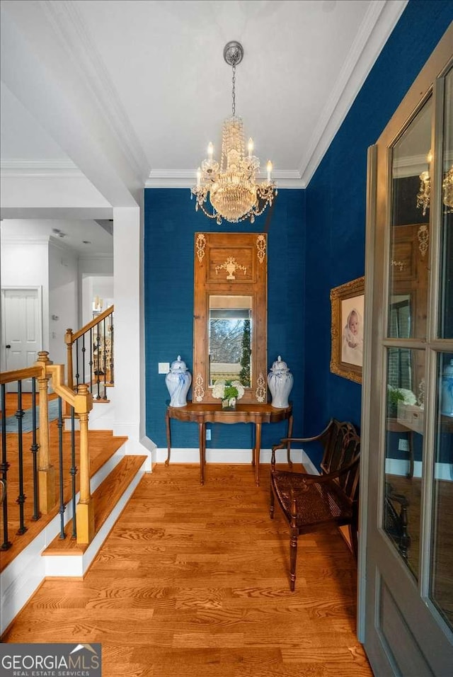 interior space with an inviting chandelier, crown molding, and wood-type flooring