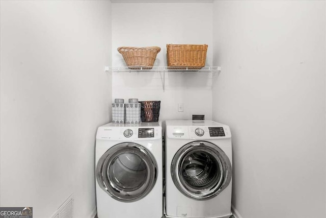 laundry area featuring washing machine and clothes dryer