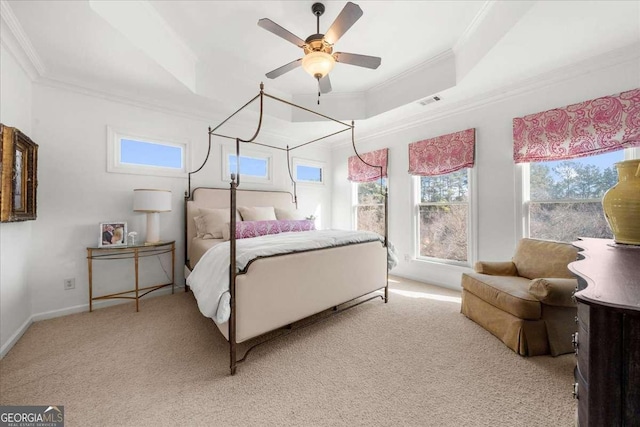 bedroom with ornamental molding, a raised ceiling, and light carpet