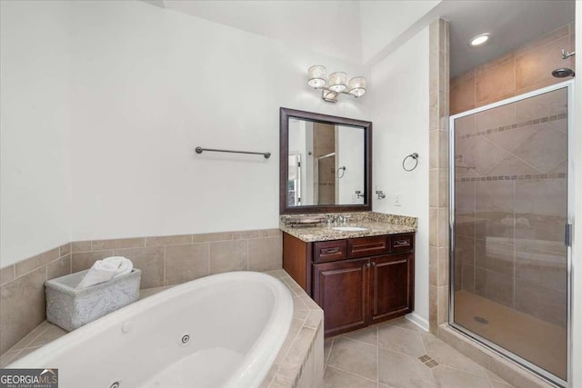 bathroom featuring tile patterned flooring, vanity, and shower with separate bathtub