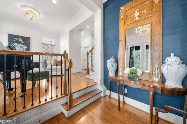 stairs with wood-type flooring, ornamental molding, and french doors