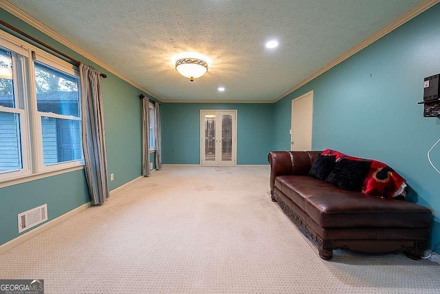 living room featuring crown molding, carpet floors, and a textured ceiling