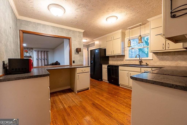 kitchen featuring white cabinetry, decorative light fixtures, black appliances, and light wood-type flooring