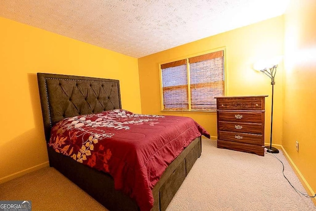 bedroom with carpet flooring and a textured ceiling