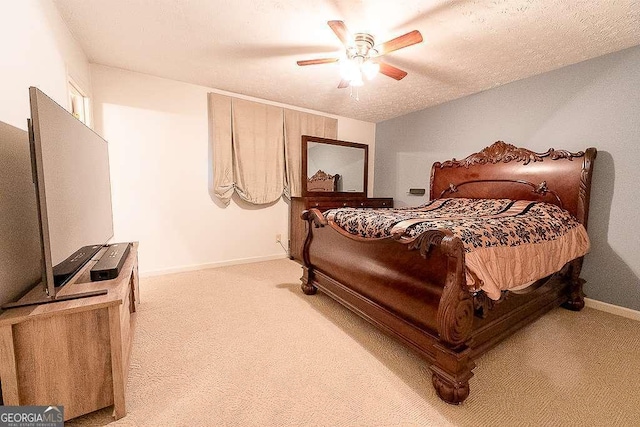 carpeted bedroom with a textured ceiling and ceiling fan