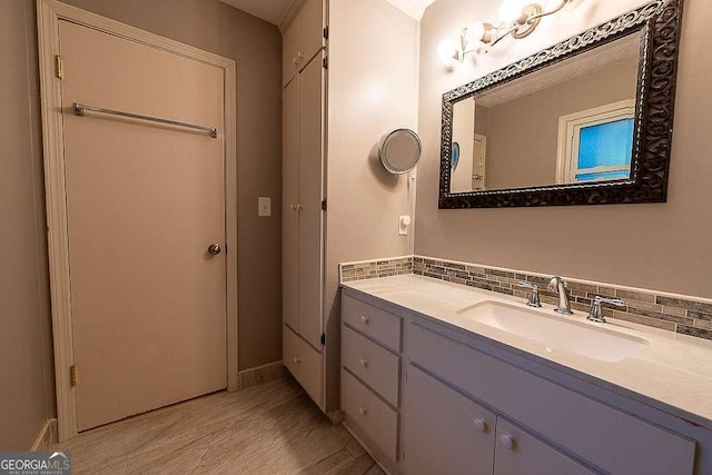 bathroom with vanity and decorative backsplash