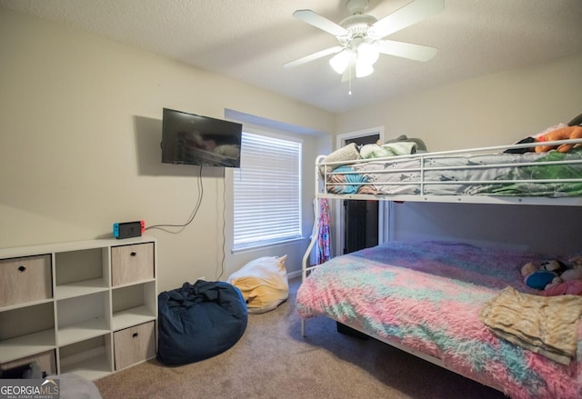 bedroom featuring a textured ceiling, carpet floors, and ceiling fan