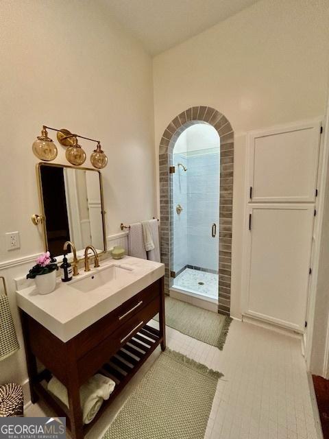 bathroom featuring vanity and a shower with door