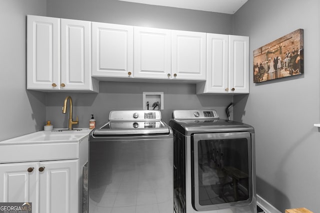 laundry room featuring separate washer and dryer, sink, and cabinets