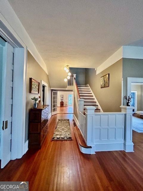 interior space with lofted ceiling, hardwood / wood-style flooring, and a textured ceiling