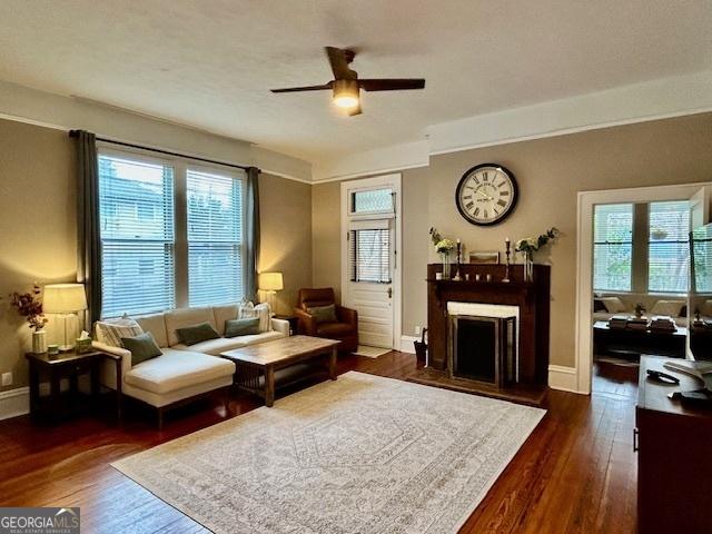 sitting room with dark hardwood / wood-style floors and ceiling fan