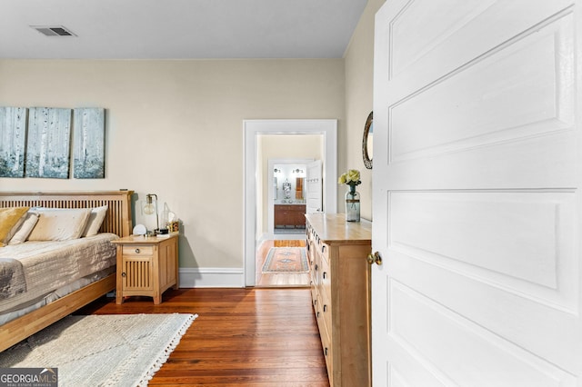 bedroom featuring dark hardwood / wood-style flooring