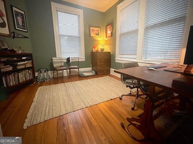 home office with hardwood / wood-style flooring