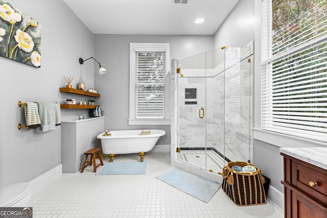 bathroom featuring shower with separate bathtub, a healthy amount of sunlight, vanity, and tile patterned floors