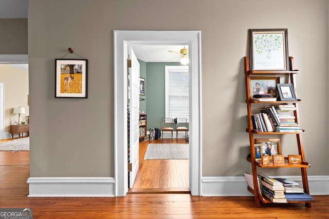 corridor with hardwood / wood-style floors