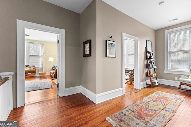 sitting room with wood-type flooring