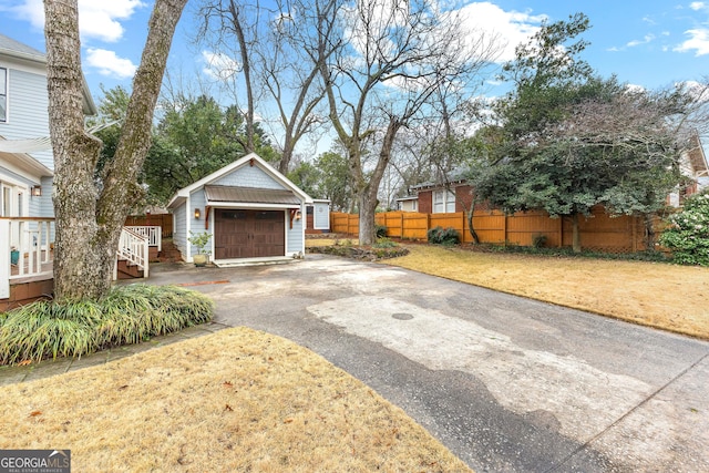 exterior space featuring a garage, an outdoor structure, and a front yard