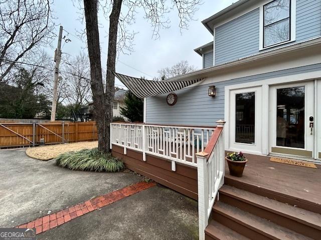 wooden terrace with a patio area