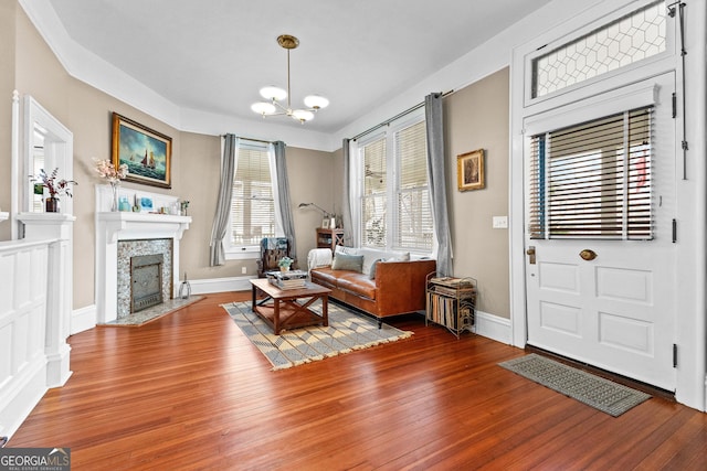 sitting room with hardwood / wood-style floors and a chandelier