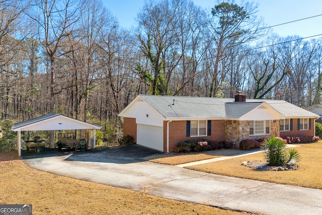 view of front of home featuring a garage, a carport, and a front lawn